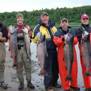 a fishing group poses with the salmon they caught on alaska's nushagak river with a guide near our lodge