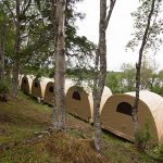 Weatherports lined up for guests overlooking the Nushagak River.