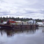 A photo of a barge navigating the Nushagak River